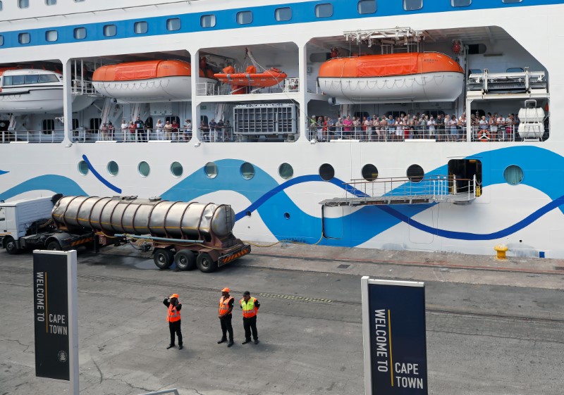 © Reuters. Passengers wait aboard the cruise liner MV AidAmira as the ship sits at dock in Cape Town