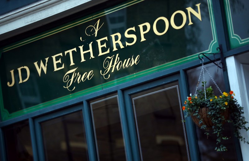 © Reuters. A Wetherspoon's logo is seen at a pub in central London