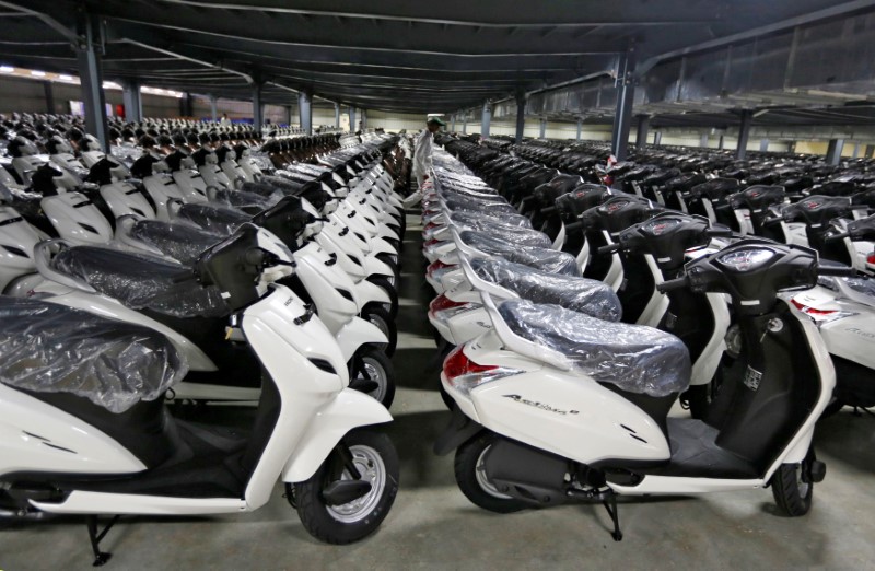 &copy; Reuters. FILE PHOTO: New scooters are pictured at a stock yard during a media tour to the newly inaugurated second assembly line of a Honda Motorcycle &amp; Scooter India manufacturing plant in Vithalapur