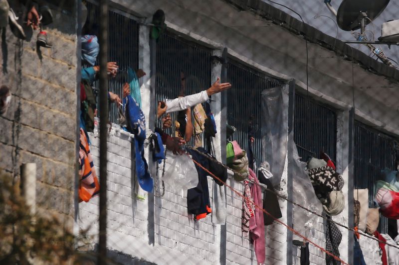 &copy; Reuters. Prisoners are seen in cell windows inside the La Modelo prison after a riot by prisoners demanding government health measures against the spread of the coronavirus disease (COVID-19) in Bogota