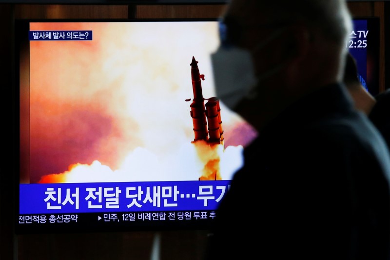 &copy; Reuters. A man walks past a TV broadcasting file footage for a news report on North Korea firing an unidentified projectile, in Seoul