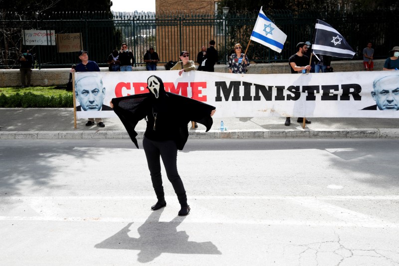 &copy; Reuters. An Israeli woman wears a costume during a demonstration against PM Netanyahu&apos;s caretaker government in Jerusalem