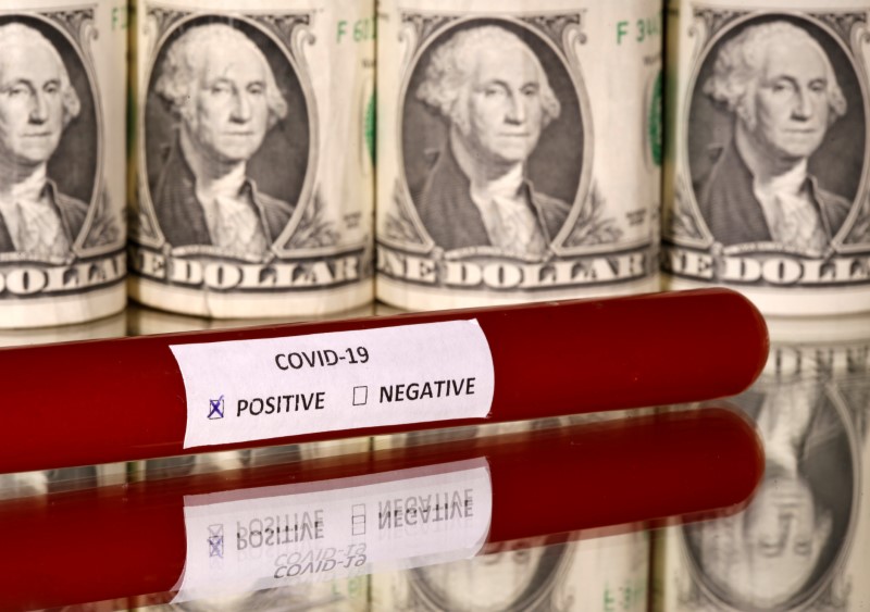 &copy; Reuters. FILE PHOTO: Picture illustration of a test tube labelled with the coronavirus is seen in front of U.S. dollar banknotes