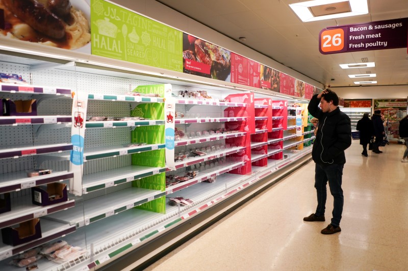 &copy; Reuters. A man stands next to shelves empty of fresh meat in a supermarket, as the number of worldwide coronavirus cases continues to grow,  in London