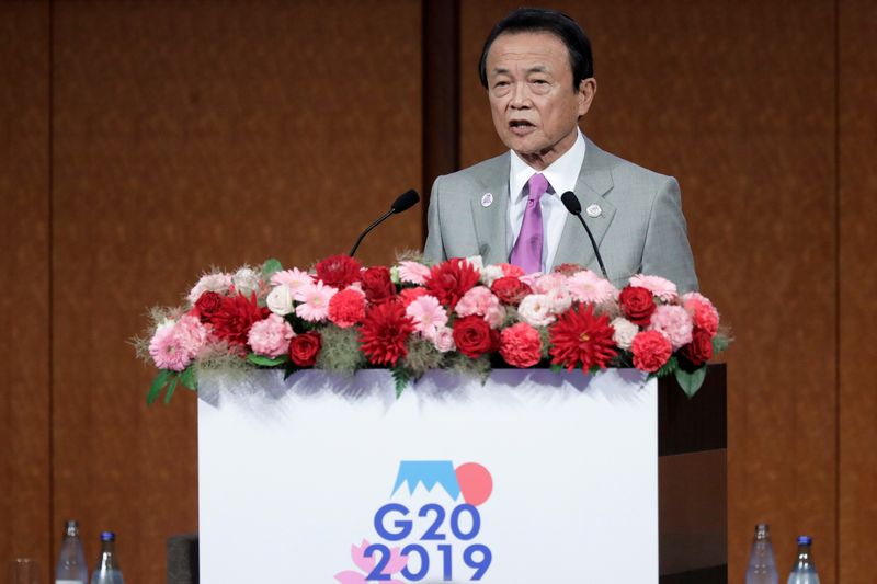 &copy; Reuters. Taro Aso, Japan&apos;s deputy prime minister and finance minister, speaks at the Group of 20 (G-20) high-level seminar on financial innovation &quot;Our Future in the Digital Age&quot; in Fukuoka