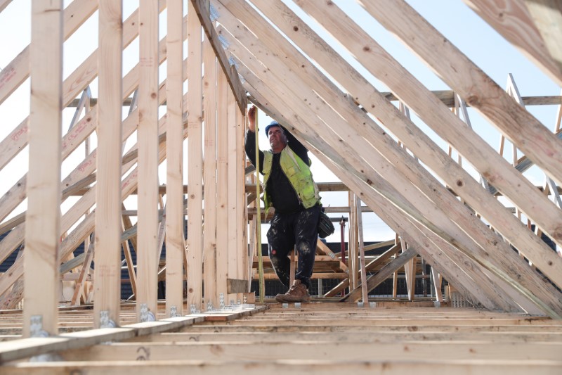 &copy; Reuters. FILE PHOTO:  A builder working for Taylor Wimpey builds a roof on an estate in Aylesbury
