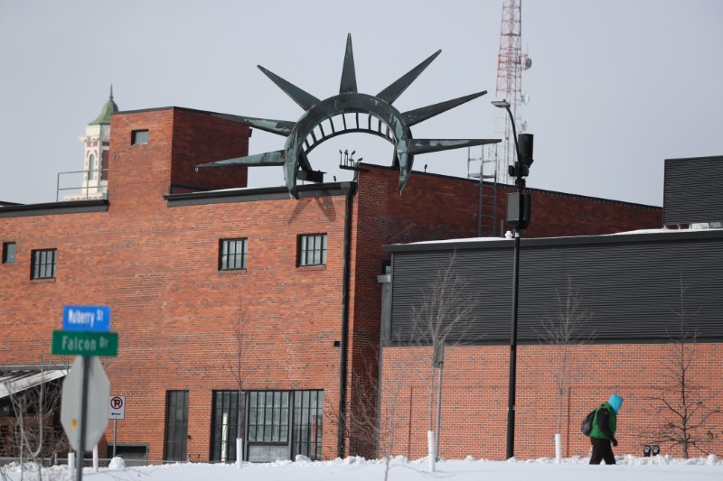 &copy; Reuters. Man walks past a factory at Des Moines, Iowa