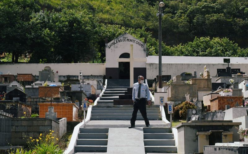 &copy; Reuters. A security officer is seen at the Municipal cemetery, where the 63-year-old maid Leonice Goncalves was buried after she was infected with coronavirus by her boss, according to state and local officials, in Miguel Pereira