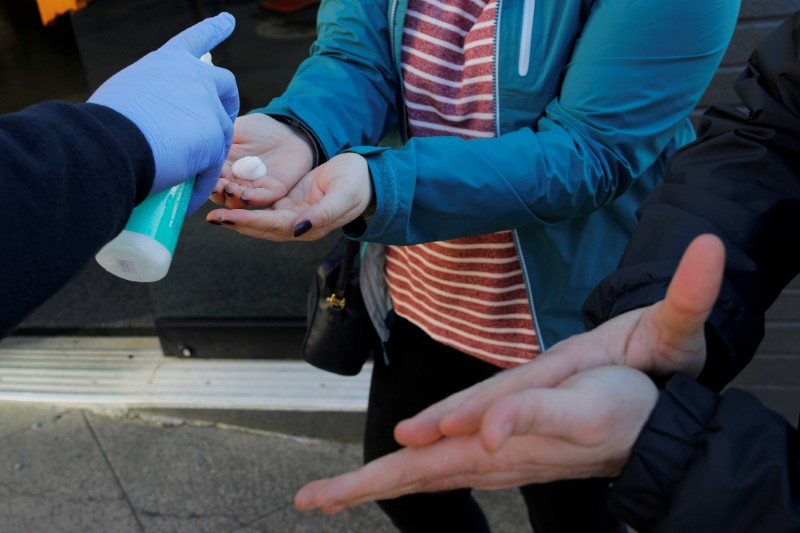 &copy; Reuters. FILE PHOTO: Customers are given hand sanitizer before being allowed to enter The Reef Cannabis shop in Seattle