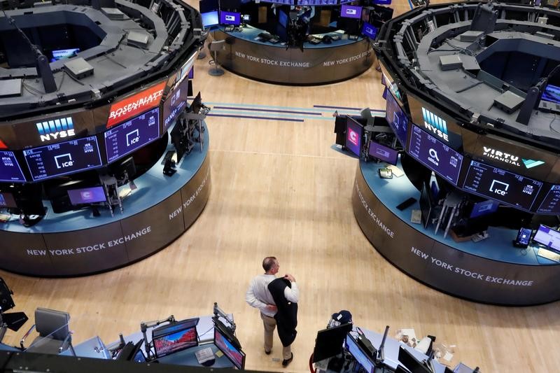 &copy; Reuters. A trader puts on his jacket on the floor of the New York Stock Exchange (NYSE) as the building prepares to close indefinitely due to the coronavirus disease (COVID-19) outbreak in New York