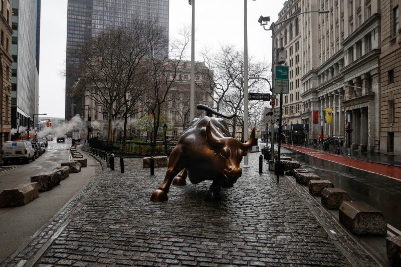 &copy; Reuters. The Wall St. Bull is seen standing on a nearly empty Broadway in the financial district, as the coronavirus disease (COVID-19) outbreak continues, in New York