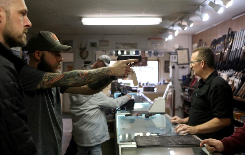 &copy; Reuters. FILE PHOTO: A man holds a semi-automatic handgun at Frontier Arms &amp; Supply gun shop amid fears of the global growth of coronavirus disease (COVID-19) cases, in Cheyenne
