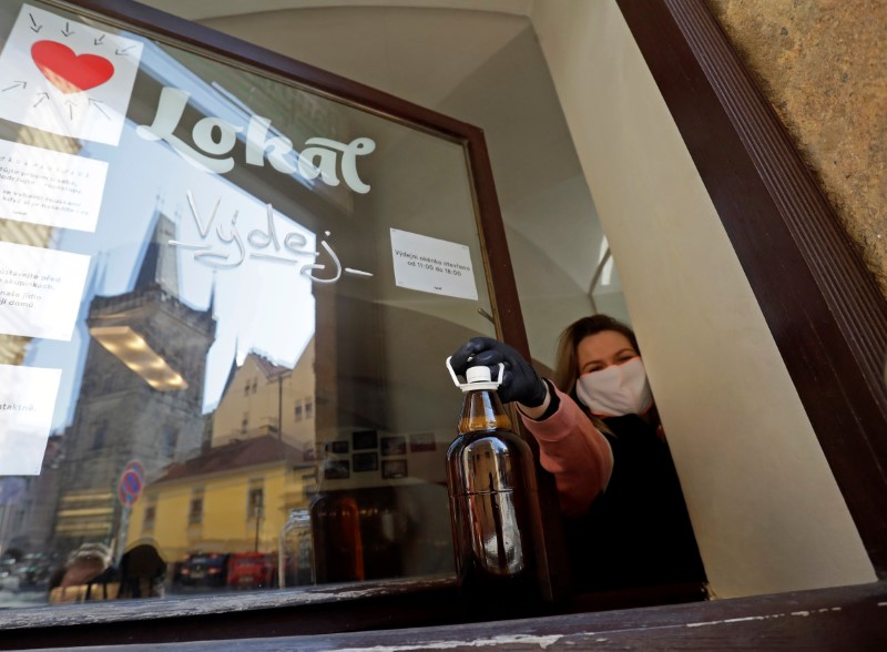 &copy; Reuters. A waitress passes a plastic bottle of beer to a customer in Prague