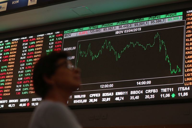 © Reuters. Mulher observa painel na B3, a bolsa de valores de São Paulo