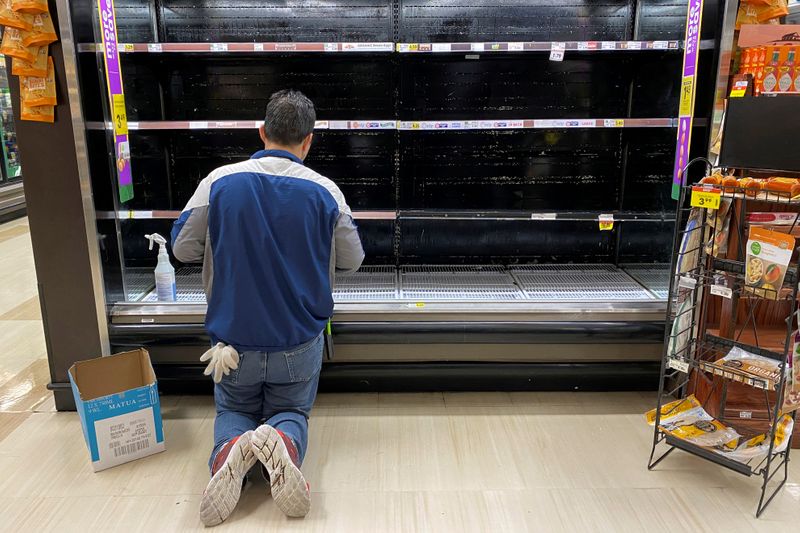 &copy; Reuters. FILE PHOTO: A store worker cleans an empty display for eggs inside Kroger Co.&apos;s Ralphs supermarket amid fears of the global growth of coronavirus cases, in Los Angeles, California