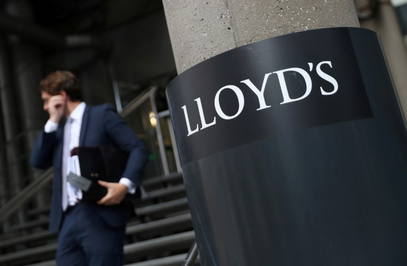 &copy; Reuters. FILE PHOTO: A man walks out of Lloyds of London&apos;s headquarters in the City of London