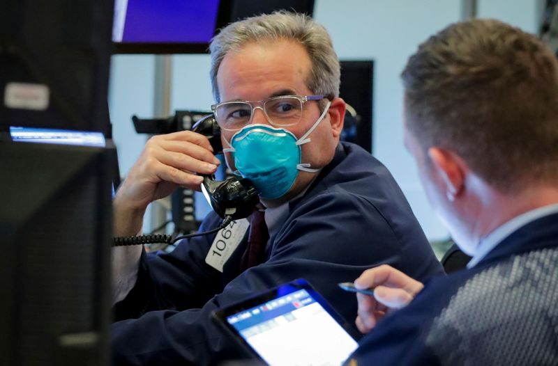 &copy; Reuters. FILE PHOTO: A trader wears a face mask on the floor  of the NYSE in New York