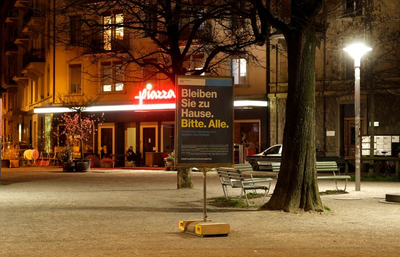 &copy; Reuters. Sign reads &quot;Please stay at home. All.&quot; on trendy Idaplatz square in Zurich