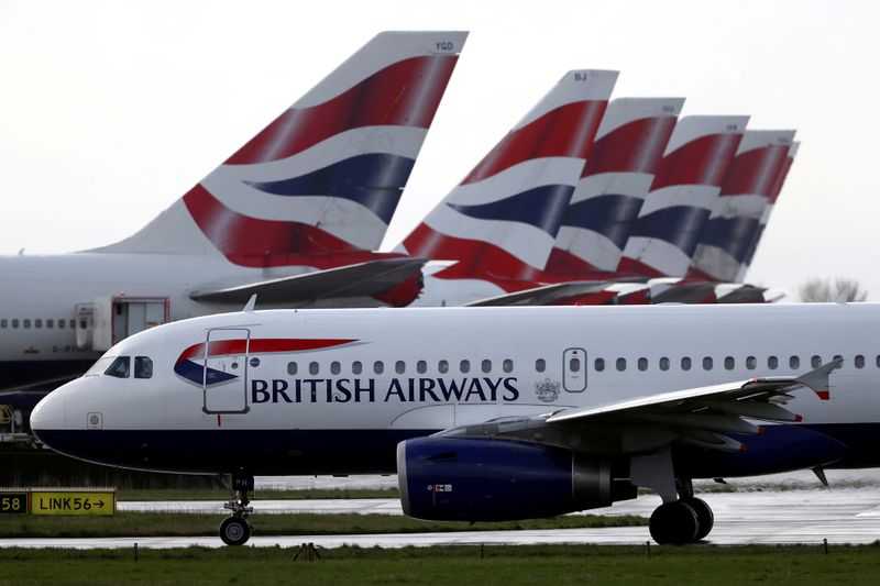 &copy; Reuters. FILE PHOTO: BA plane taxis past tail fins of parked aircraft to runway near Terminal 5 at Heathrow Airport