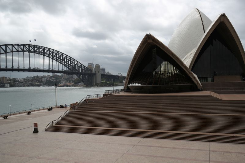 &copy; Reuters. People are seen on the nearly deserted steps of the Sydney Opera House