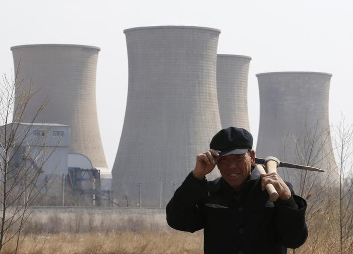 &copy; Reuters. A worker walks past a steel factory in Beijing