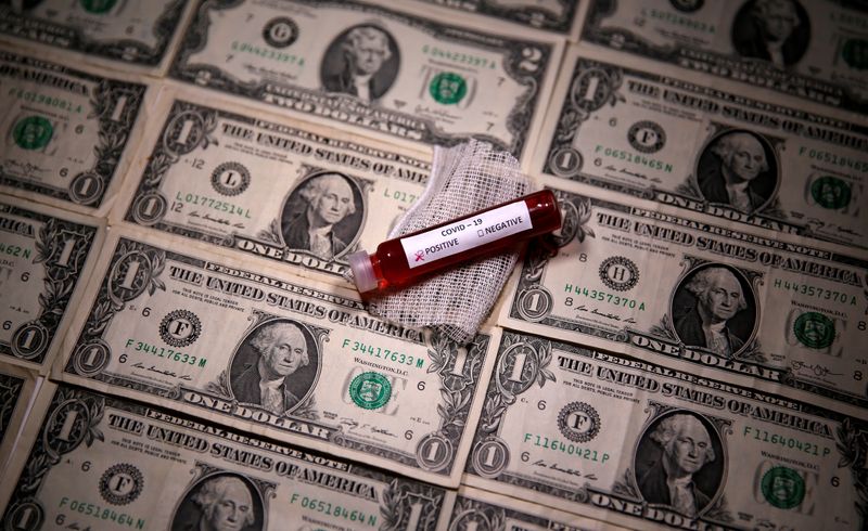 &copy; Reuters. FILE PHOTO: Test tube with fake blood labelled with the coronavirus disease (COVID-19) is placed on dollar banknotes in this illustration