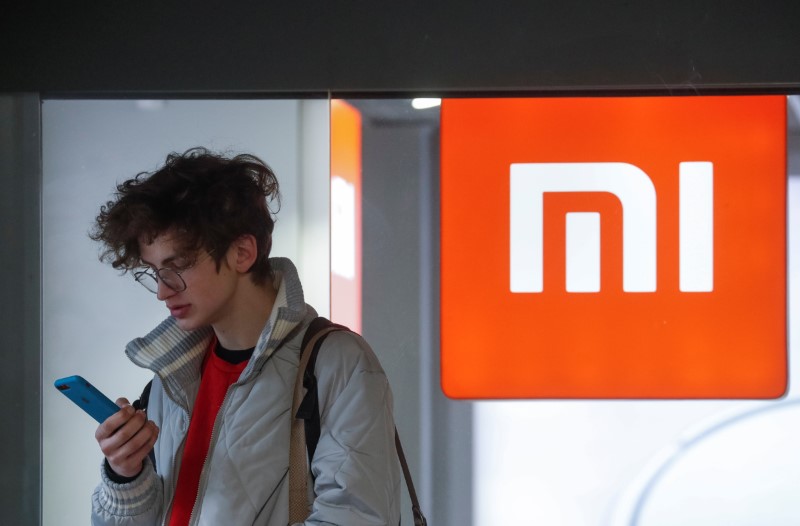 &copy; Reuters. A man uses his smartphone next to the Xiaomi brand&apos;s store in central Kiev