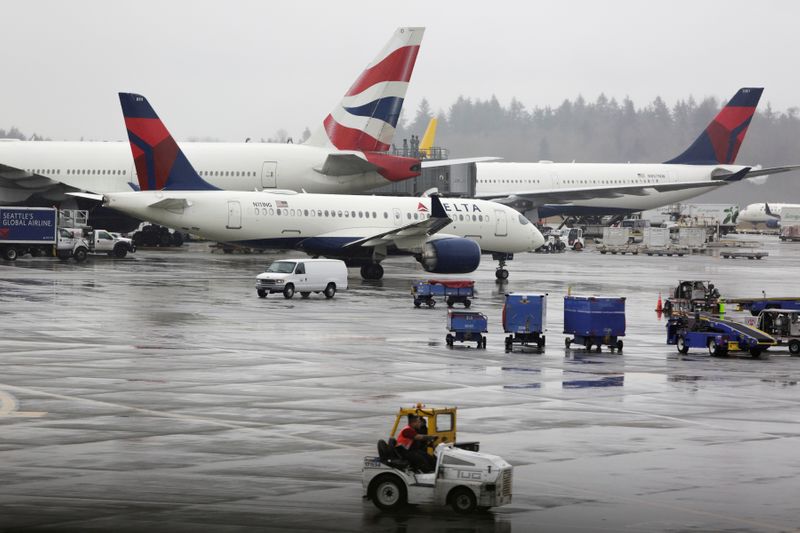&copy; Reuters. FILE PHOTO: Delta Airlines planes and a British Airways plane are pictured at Seattle-Tacoma International Airport in SeaTac, Washington