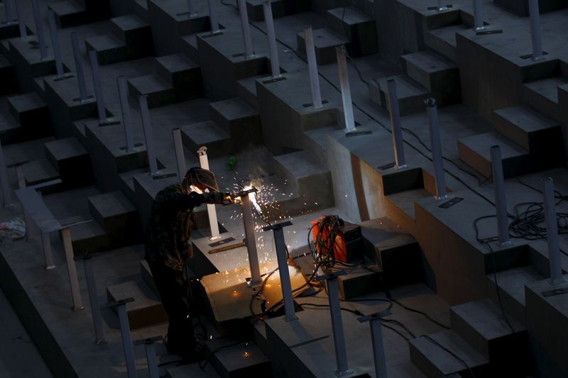 &copy; Reuters. A worker welds at a market under construction in Kunming