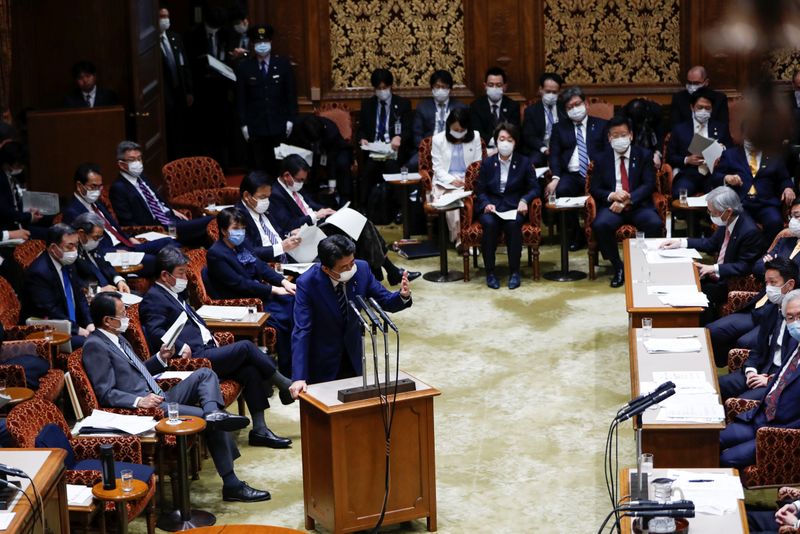 © Reuters. Japan's Prime Minister Shinzo Abe wears a protective face mask as he attends an upper house parliamentary session