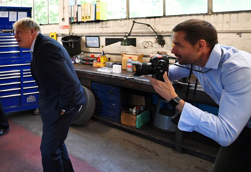 &copy; Reuters. Andrew Parsons, British Prime Minister Boris Johnson&apos;s official photographer, takes a picture of Johnson at an event in Reading