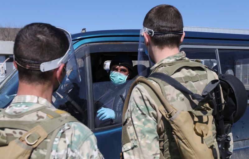 &copy; Reuters. Грузинские военные разговаривают с водителем на КПП вблизи Тбилиси