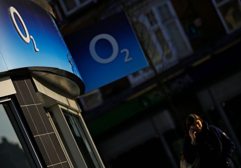 &copy; Reuters. A woman speaks on her mobile telephone outside an O2 shop in Loughborough