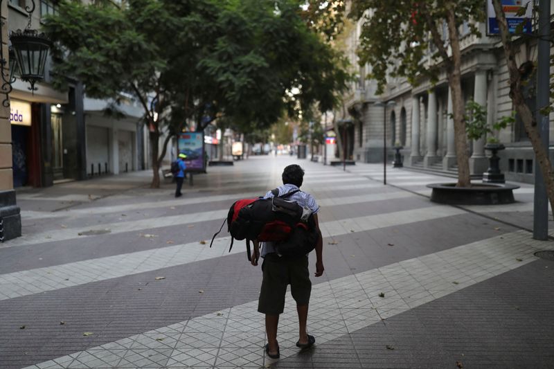 &copy; Reuters. A homeless man walks down one of Santiago&apos;s main pedestrian streets, during a preventive quarantine following the outbreak of coronavirus disease (COVID-19)