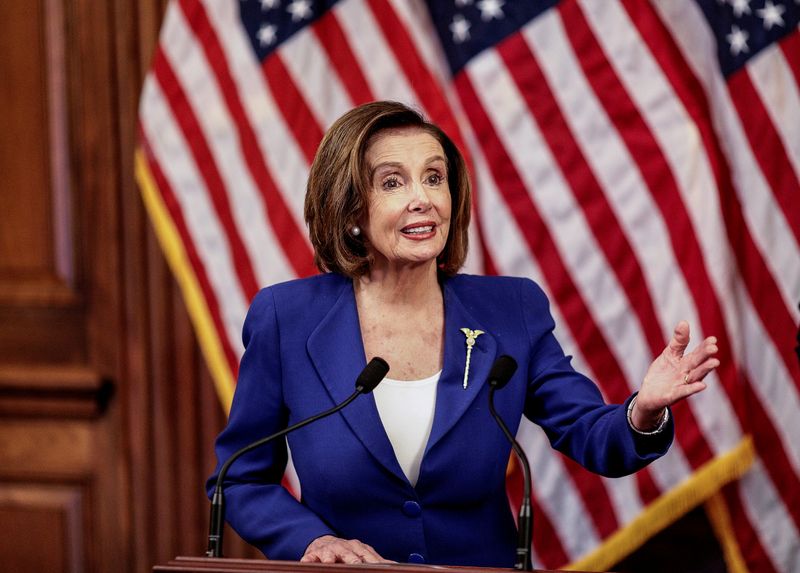 &copy; Reuters. House Speaker Pelosi holds coronavirus aid bill signing ceremony at the U.S. Capitol in Washington