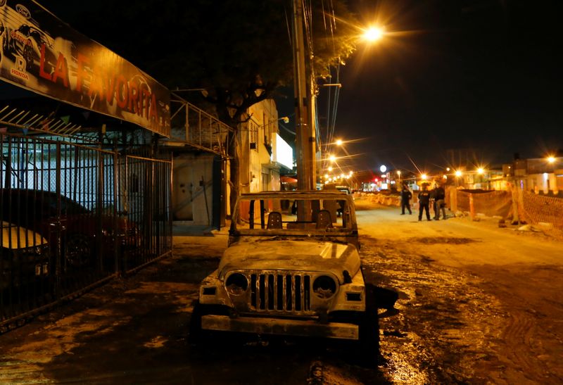 © Reuters. The wreckage of a car that was burnt by unknown assailants is pictured after an attack to a car dealership in Celaya