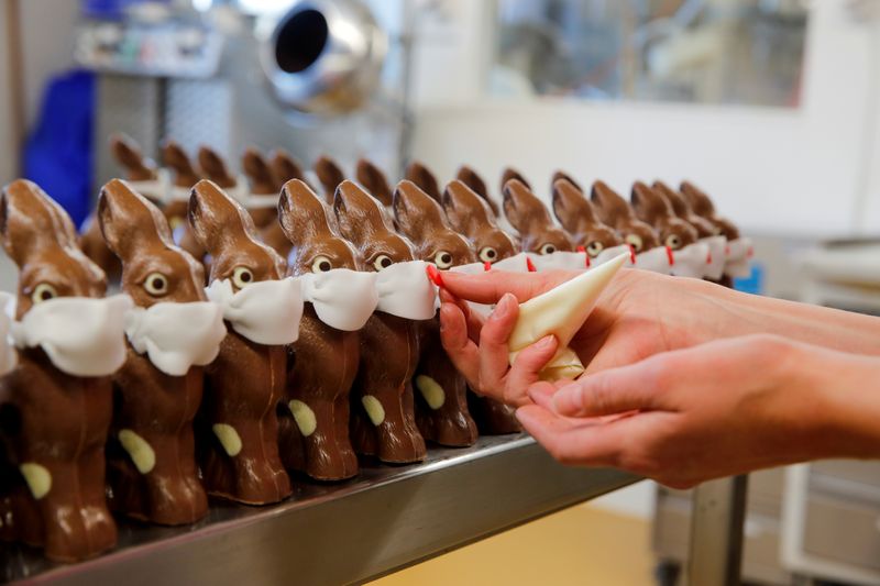 &copy; Reuters. FILE PHOTO: An employee prepares chocolate Easter bunnies wearing protective masks at Baeckerei Bohnenblust bakery in Bern