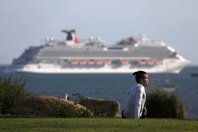 &copy; Reuters. A person stretches at a park overlooking the Pacific Ocean and Carnival Panorama cruise ship as authorities encourage social distancing to prevent the spread of coronavirus disease (COVID-19) in Long Beach, California
