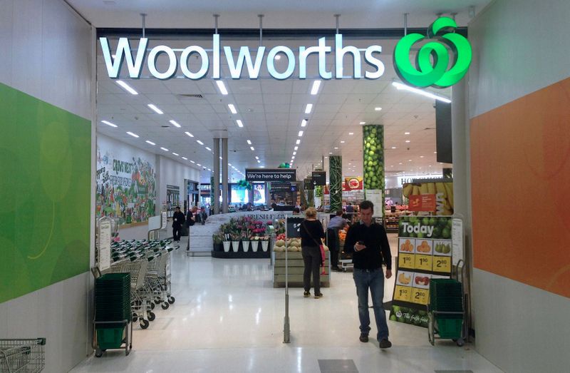 &copy; Reuters. FILE PHOTO: A shopper walks out of a Woolworths store in Sydney, Australia