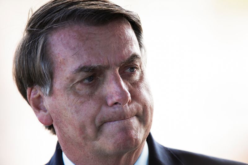 &copy; Reuters. Brazil&apos;s President Jair Bolsonaro reacts while meets supporters as he leaves Alvorada Palace, as the spread of coronavirus disease (COVID-19) continues, in Brasilia