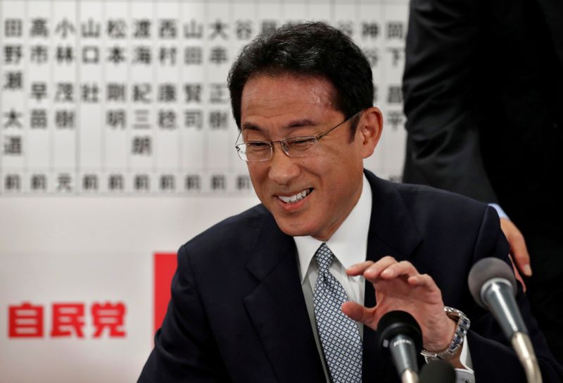 &copy; Reuters. Japan&apos;s ruling Liberal Democratic Party policy chief Fumio Kishida smiles as he speaks with the media after Japan&apos;s lower house election at the LDP headquarters in Tokyo