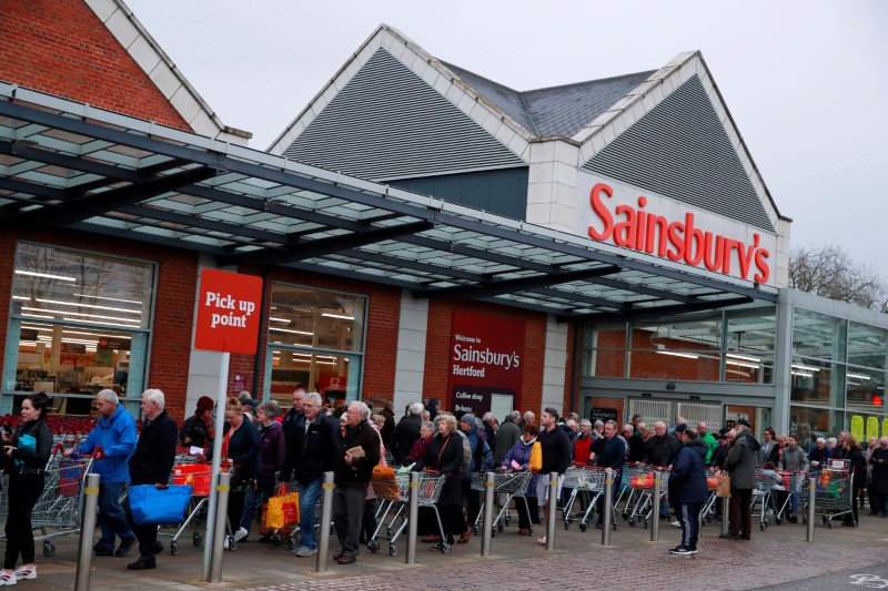 &copy; Reuters. FILE PHOTO: Elderly people wait for a Sainsburys supermarket in Hertford to open