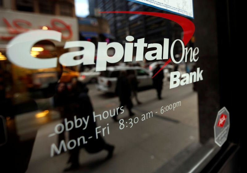 &copy; Reuters. FILE PHOTO: People walk past a Capital One banking center in New York&apos;s financial district