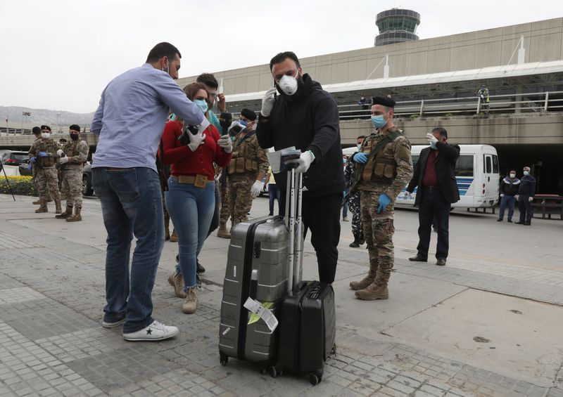 &copy; Reuters. A Lebanese, who was stranded abroad by coronavirus lockdowns, arrives at Beirut&apos;s international airport