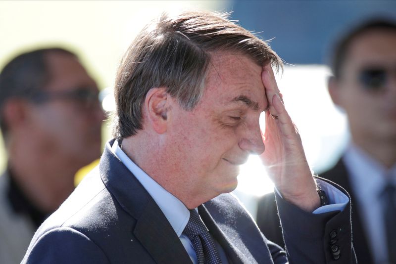 &copy; Reuters. FILE PHOTO: Brazil&apos;s President Jair Bolsonaro gestures while meeting supporters as he leaves at Alvorada Palace, amid coronavirus disease (COVID-19) outbreak, in Brasilia