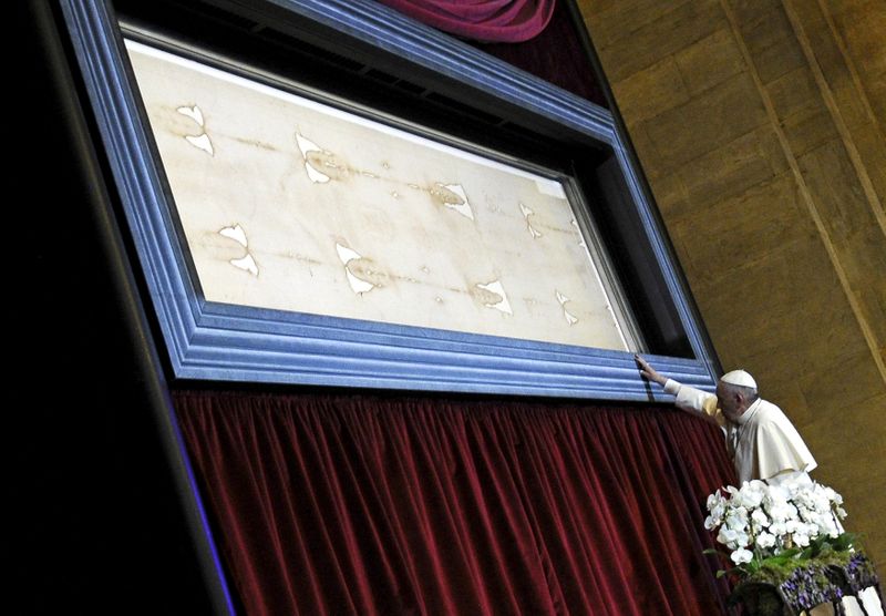 &copy; Reuters. FILE PHOTO: Pope Francis touches the Shroud of Turin during a two-day pastoral visit in Turin