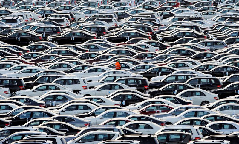 &copy; Reuters. FILE PHOTO:  A worker walks along rows of Mercedes cars at a shipping terminal in the harbour of the town of Bremerhaven