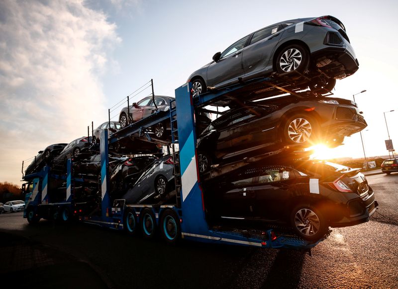 © Reuters. FILE PHOTO: A lorry with car carrier trailer leaves the Honda car plant in Swindon