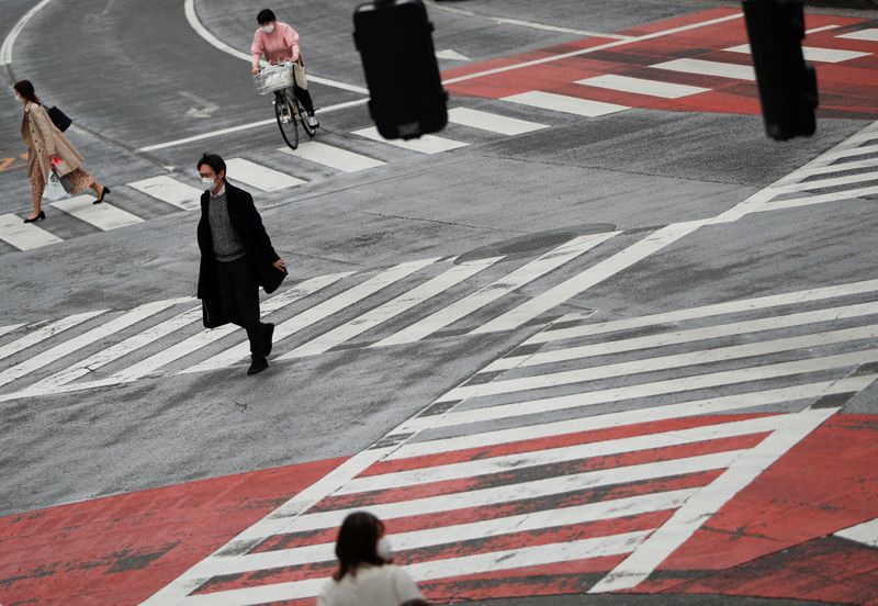 &copy; Reuters. Peatones con mascarillas faciales protectoras caminan por Shibuya en Tokio