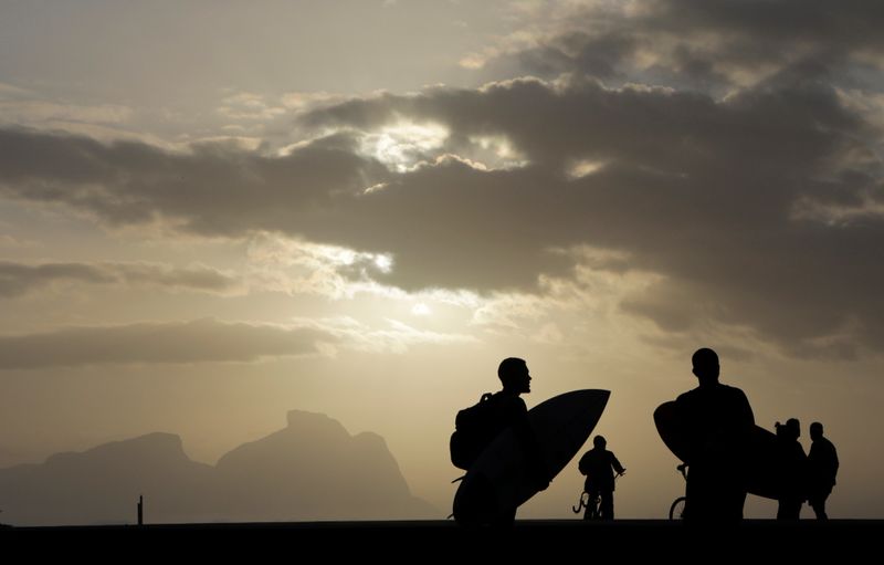 &copy; Reuters. Surfers are seen at Recreio dos Bandeirantes beach, amid the coronavirus disease (COVID-19) outbreak, in Rio de Janeiro